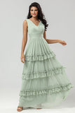 Un vestido de dama de honor verde gasa de línea con plisado